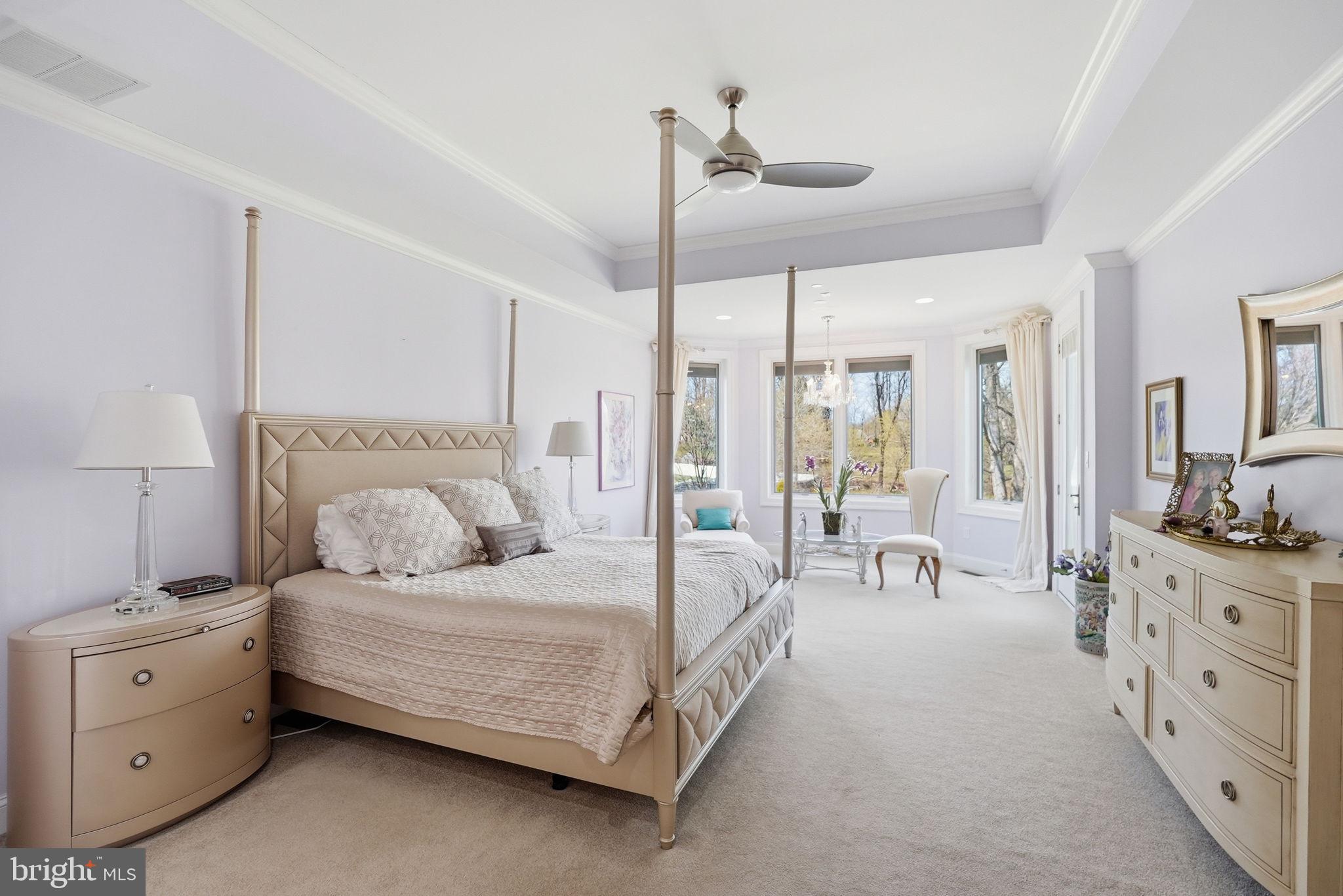 10708 Lockland Road Potomac, MD 20854 - Photo 26 of 69 a bedroom with a large bed and a chandelier