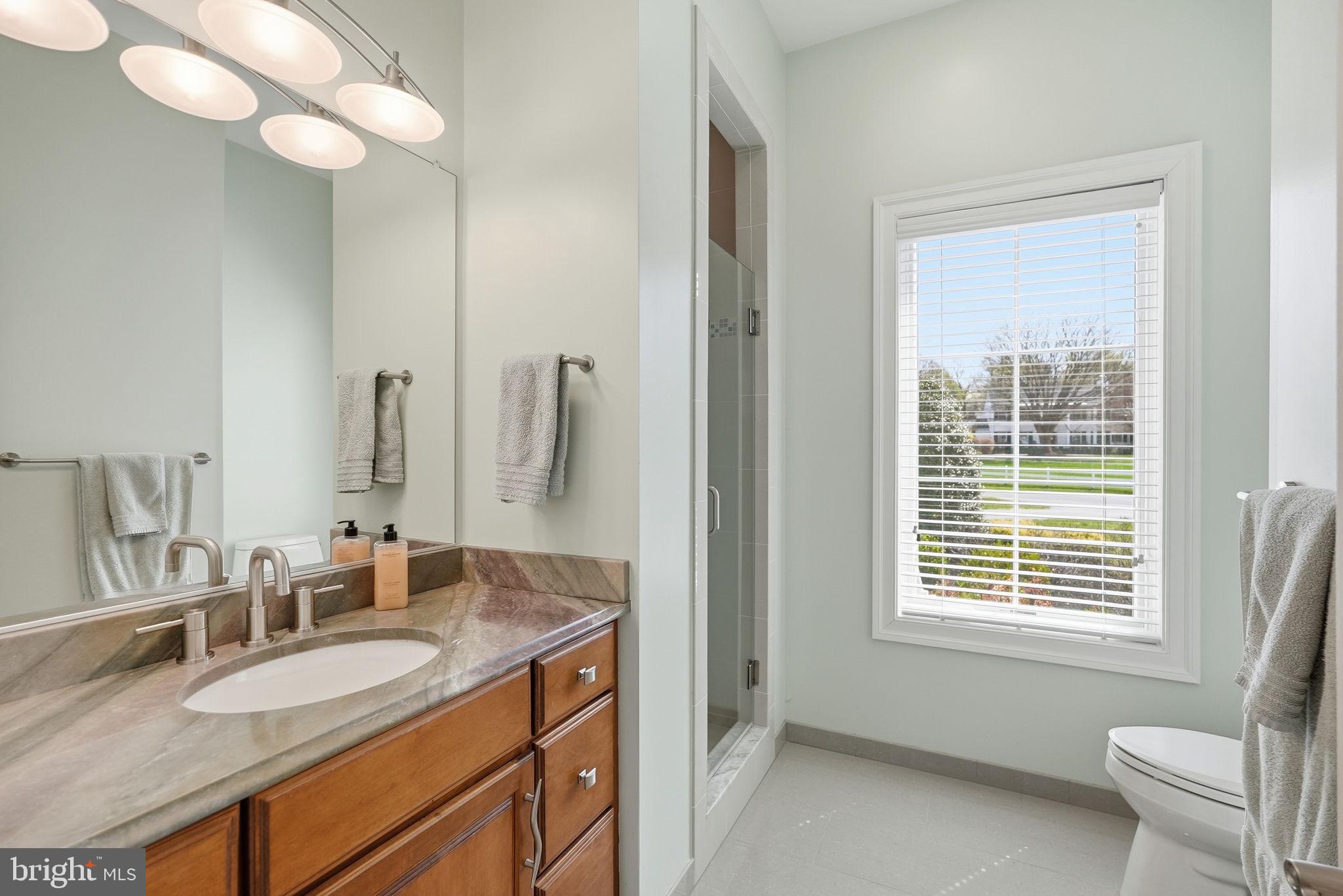 10708 Lockland Road Potomac, MD 20854 - Photo 34 of 69 a bathroom with a granite countertop sink and a mirror