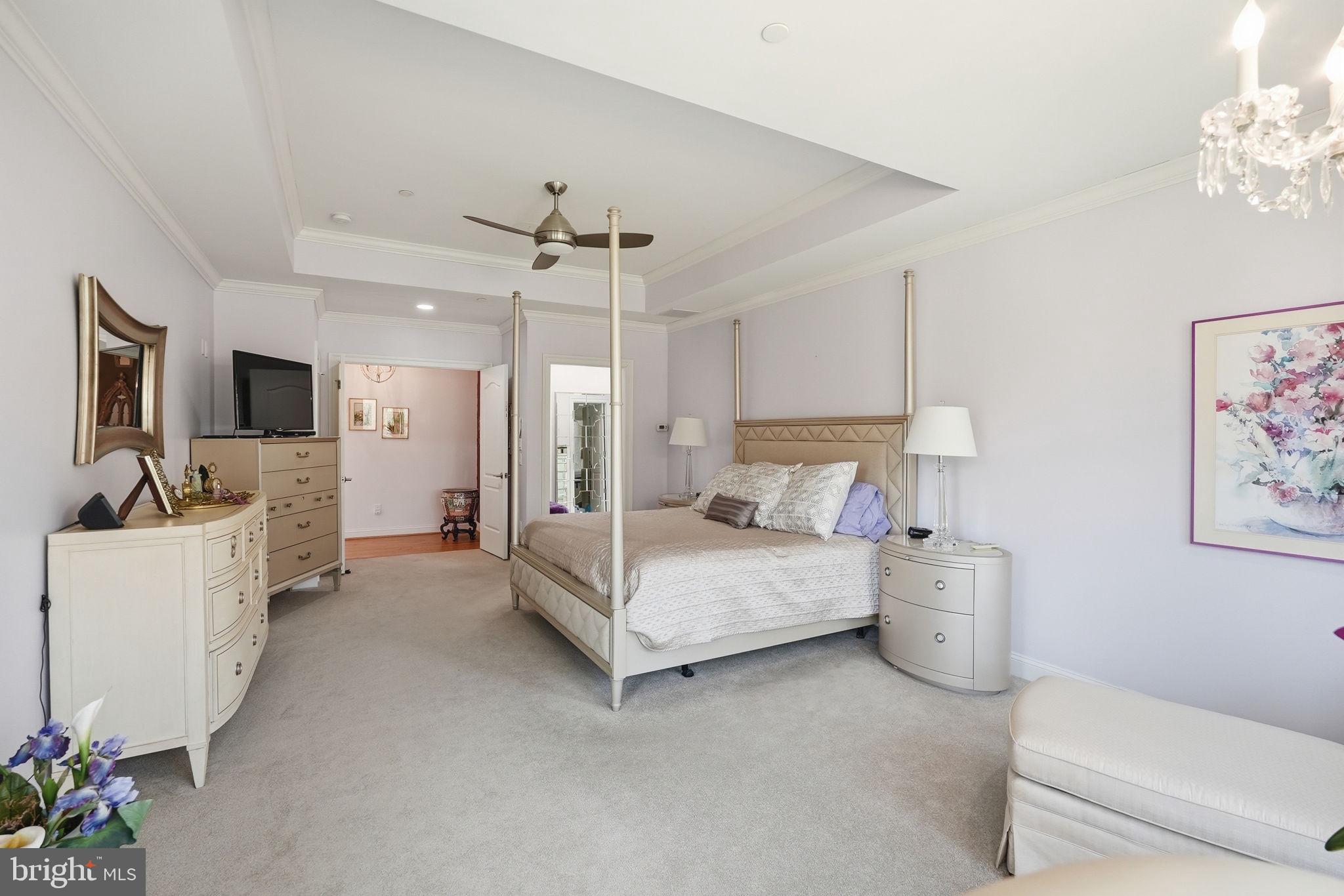 10708 Lockland Road Potomac, MD 20854 - Photo 36 of 69 a spacious bedroom with a bed and a flat screen tv