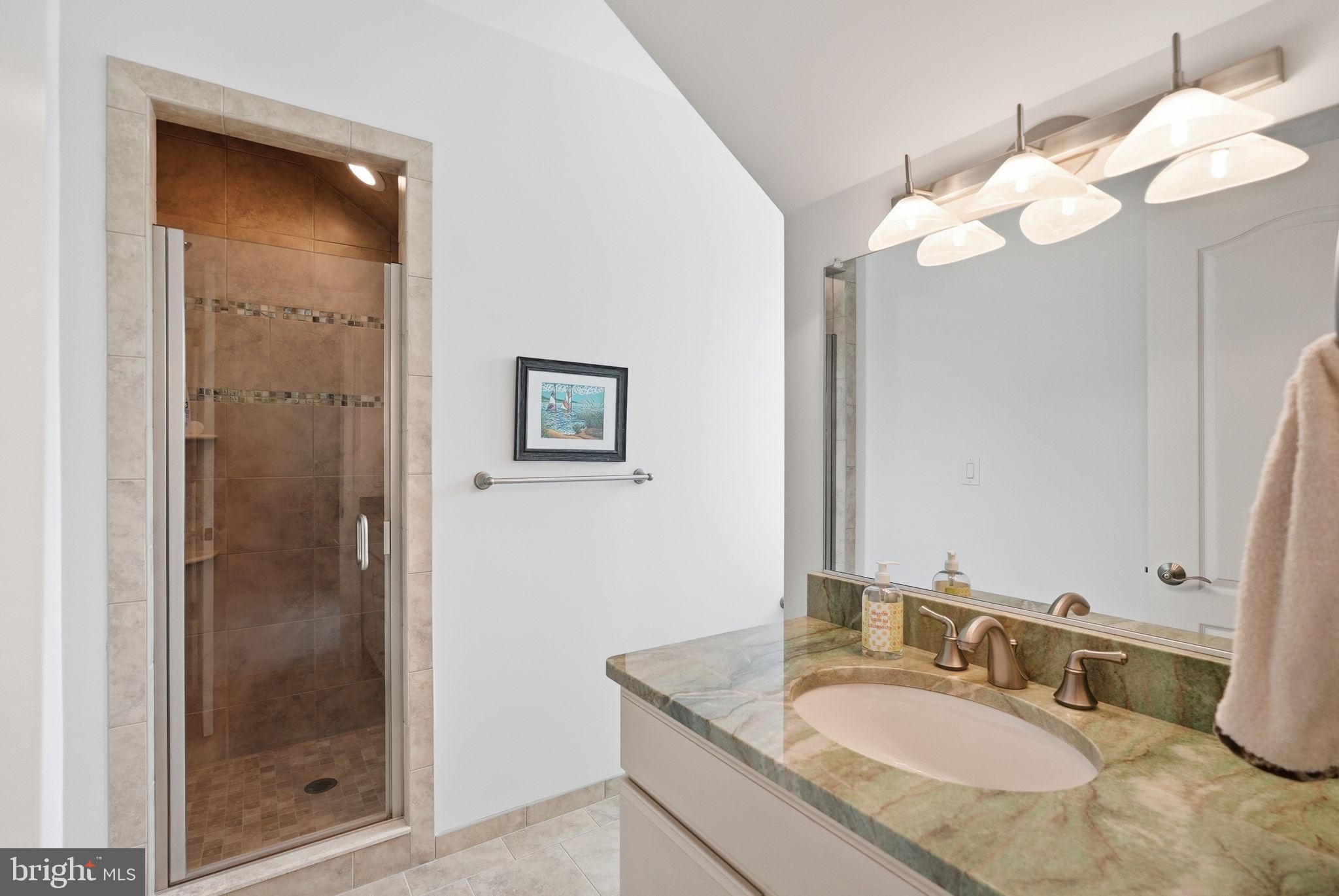 10708 Lockland Road Potomac, MD 20854 - Photo 43 of 69 a bathroom with a granite countertop sink mirror and shower