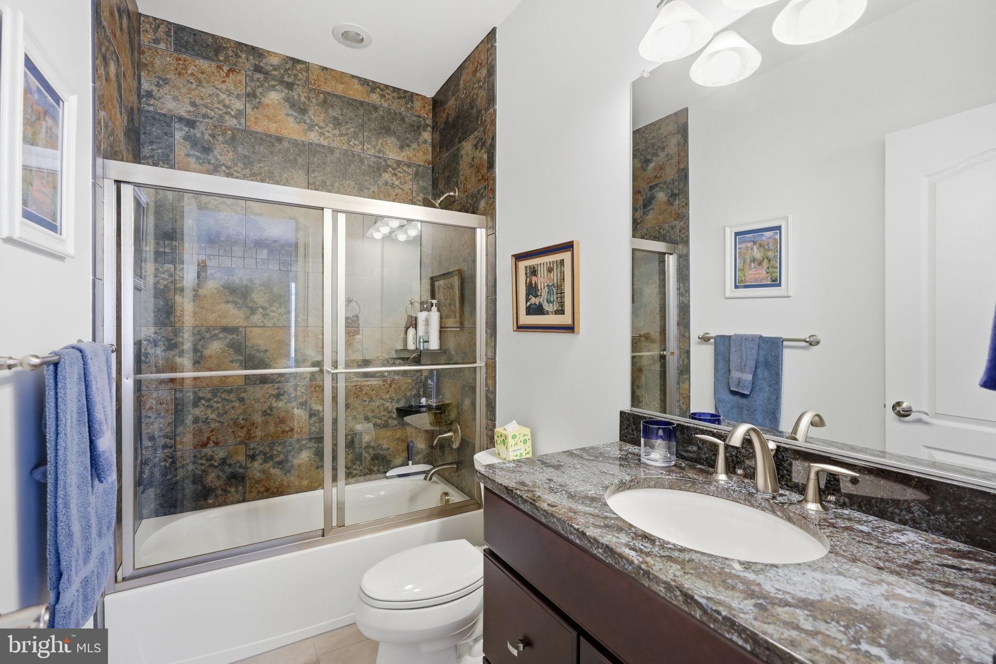 10708 Lockland Road Potomac, MD 20854 - Photo 56 of 69 a bathroom with a granite countertop sink toilet and shower