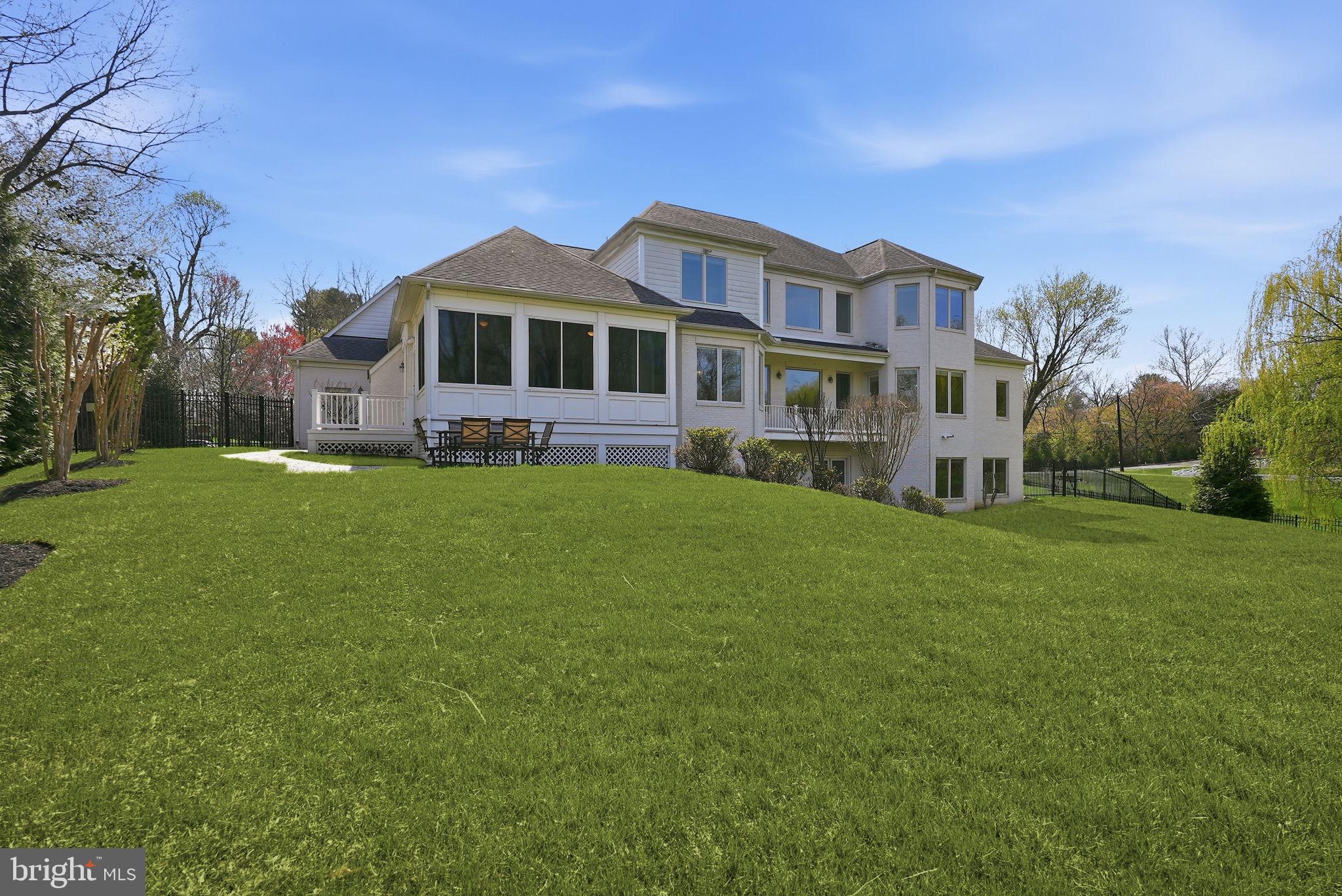 10708 Lockland Road Potomac, MD 20854 - Photo 59 of 69 a front view of a house with a garden and yard