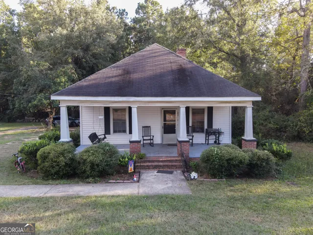 a front view of house with yard and outdoor seating