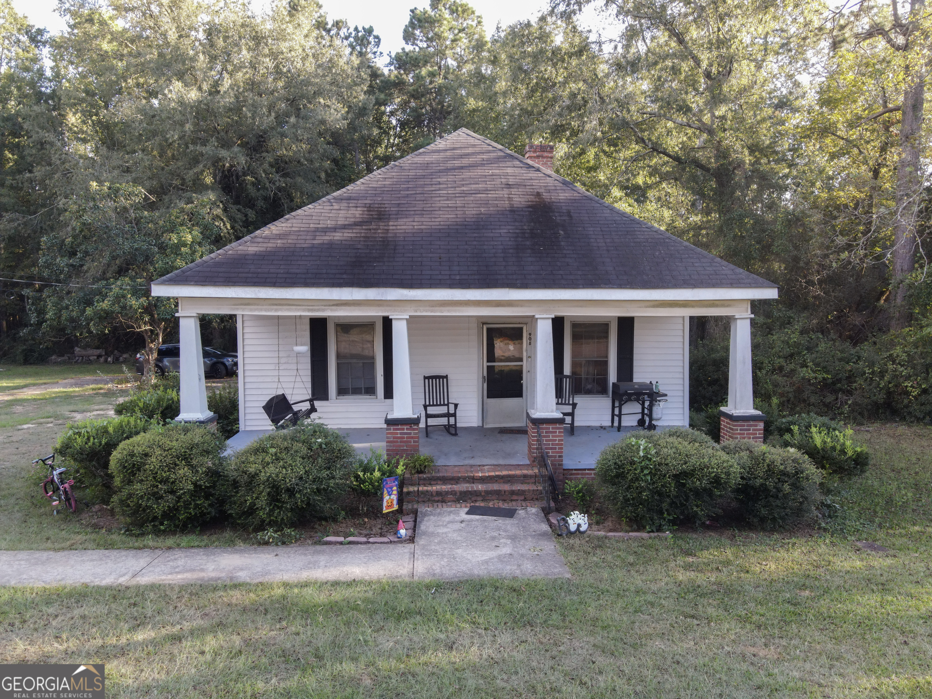 a front view of house with yard and outdoor seating