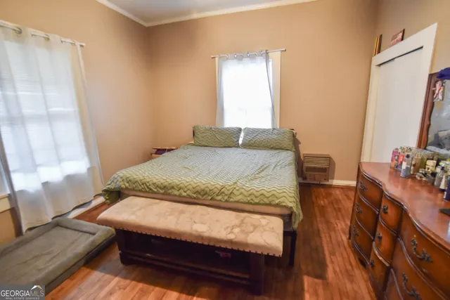 a bedroom with a bed window and a table in it