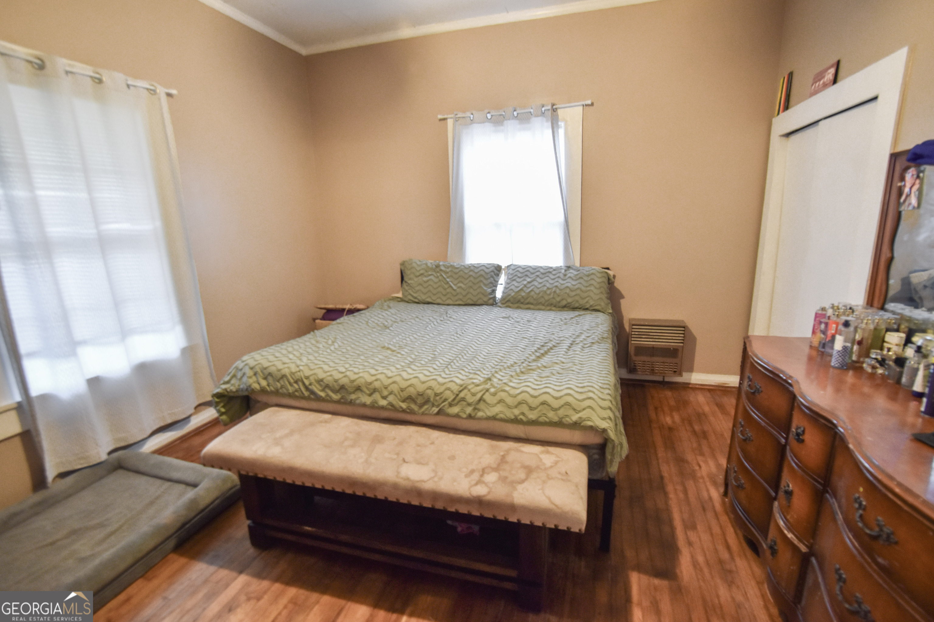 908 East McCarty Street Sandersville, GA 31082 - Photo 12 of 20 a bedroom with a bed window and a table in it