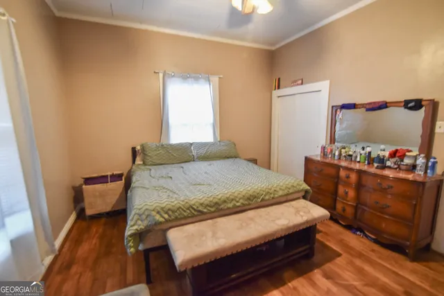 a bedroom with a bed and a dresser in it