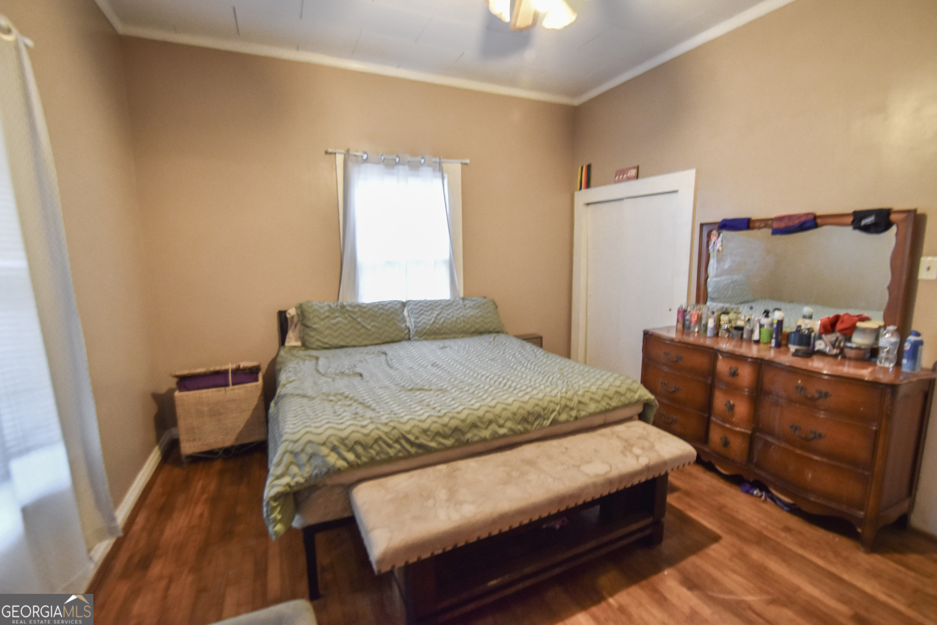 908 East McCarty Street Sandersville, GA 31082 - Photo 13 of 20 a bedroom with a bed and a dresser in it