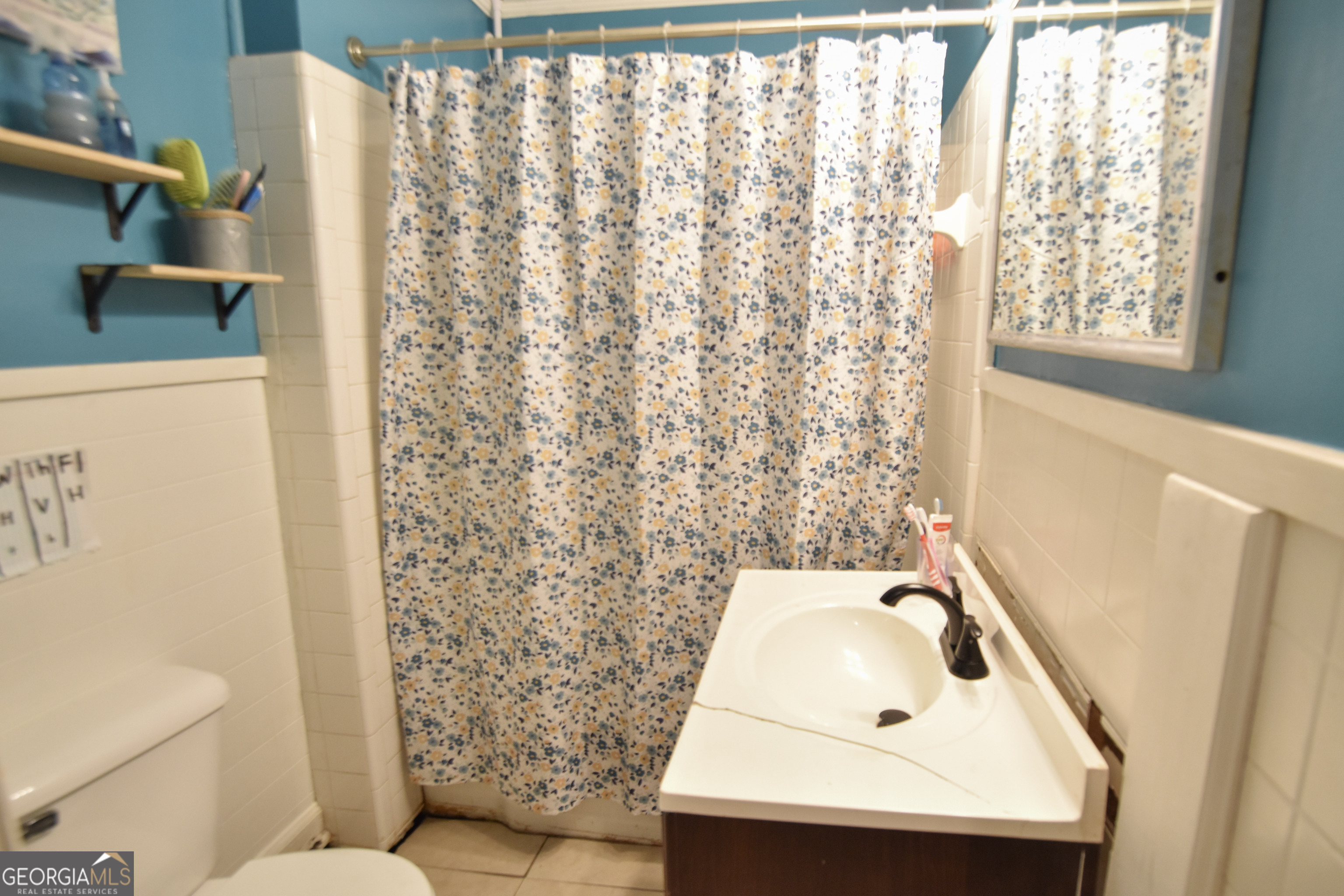 908 East McCarty Street Sandersville, GA 31082 - Photo 14 of 20 a bathroom with a sink and a toilet