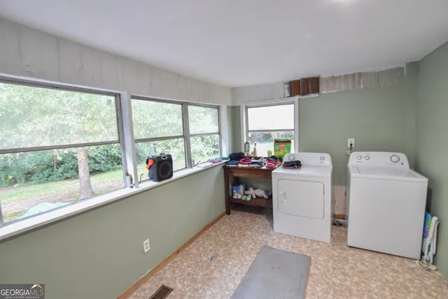 a view of storage and utility room with a window
