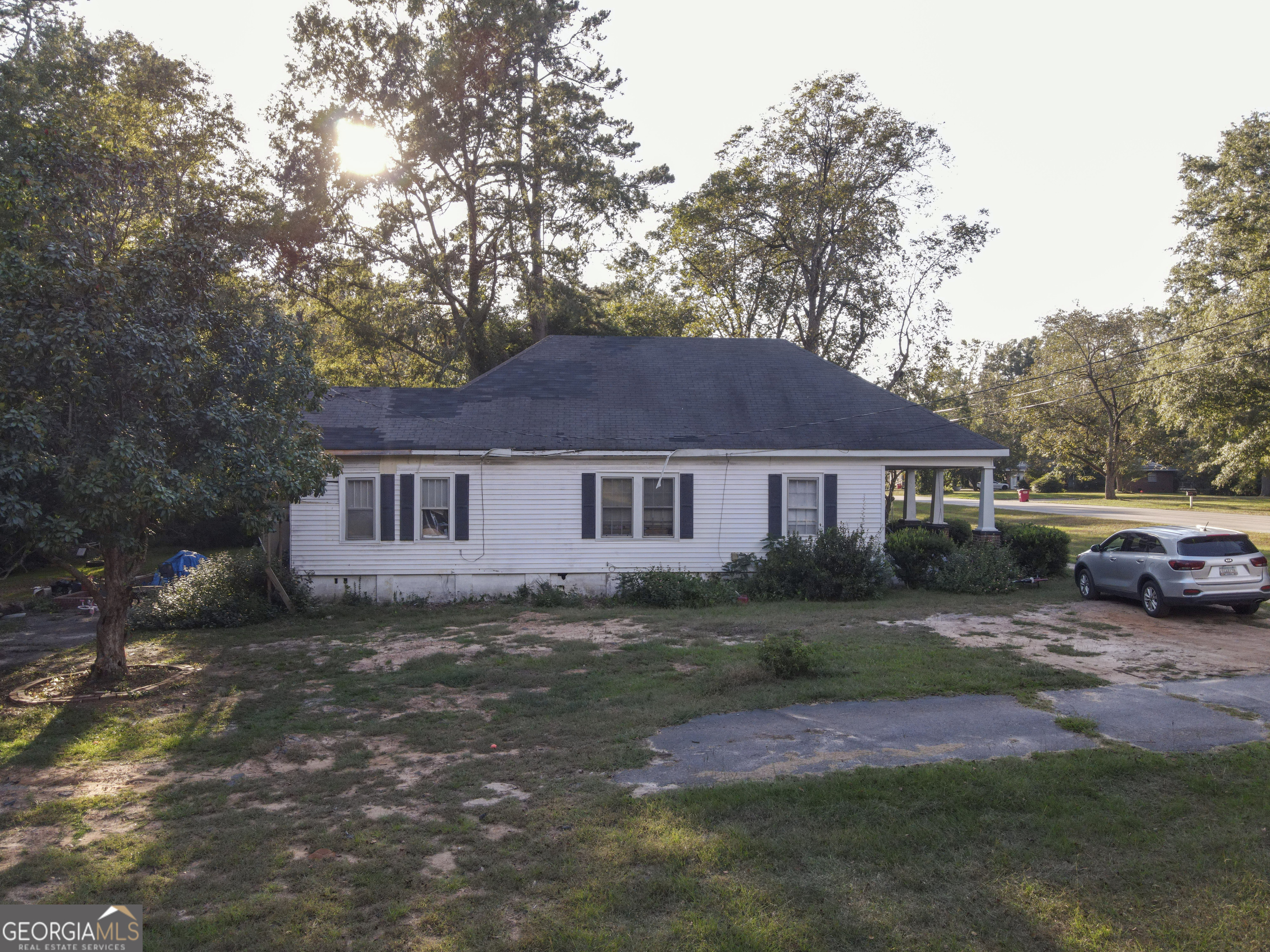 908 East McCarty Street Sandersville, GA 31082 - Photo 18 of 20 a view of a yard in front of a house with large trees