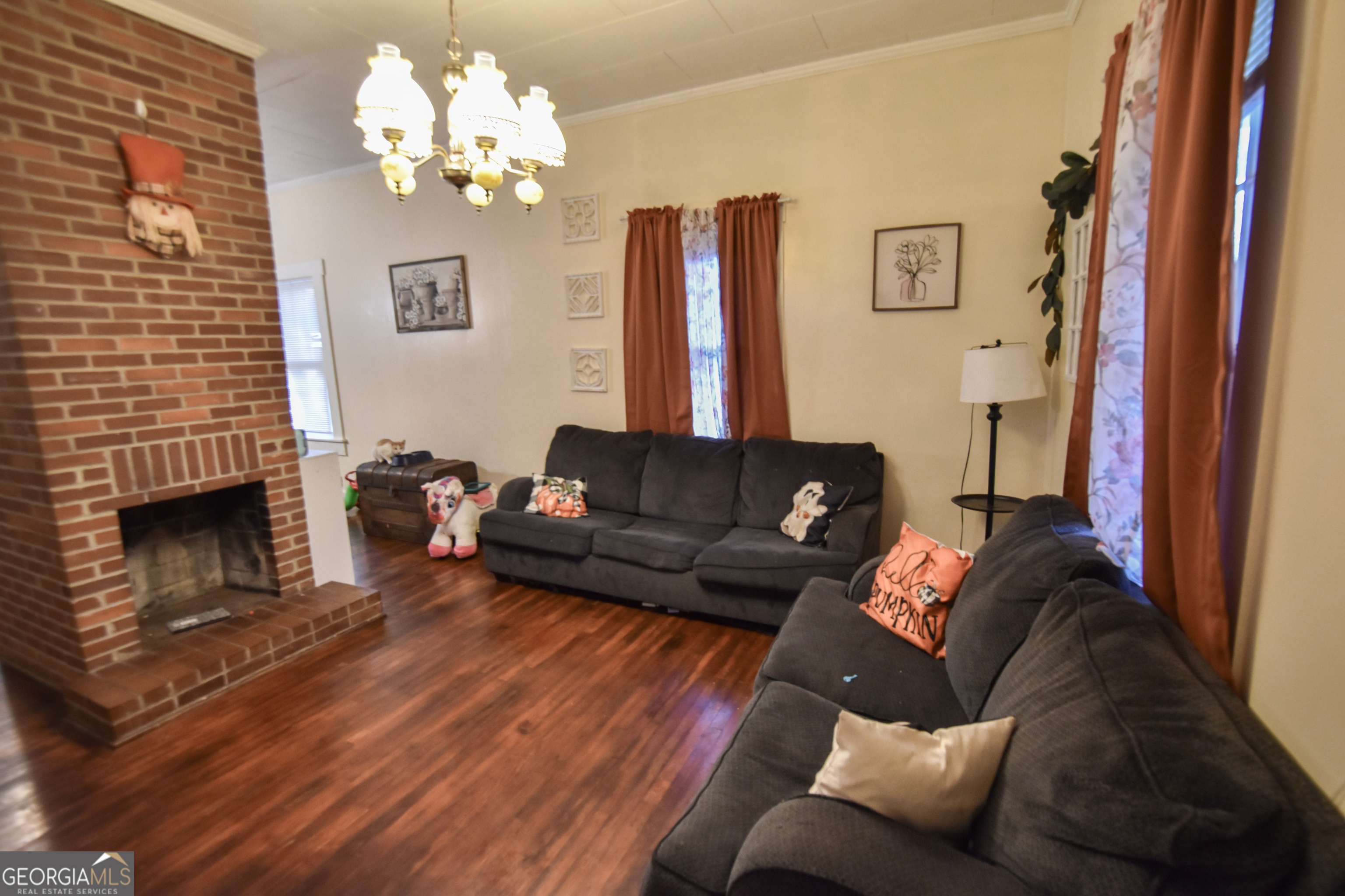 908 East McCarty Street Sandersville, GA 31082 - Photo 2 of 20 a living room with furniture and a fireplace