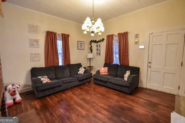 a living room with furniture and a chandelier
