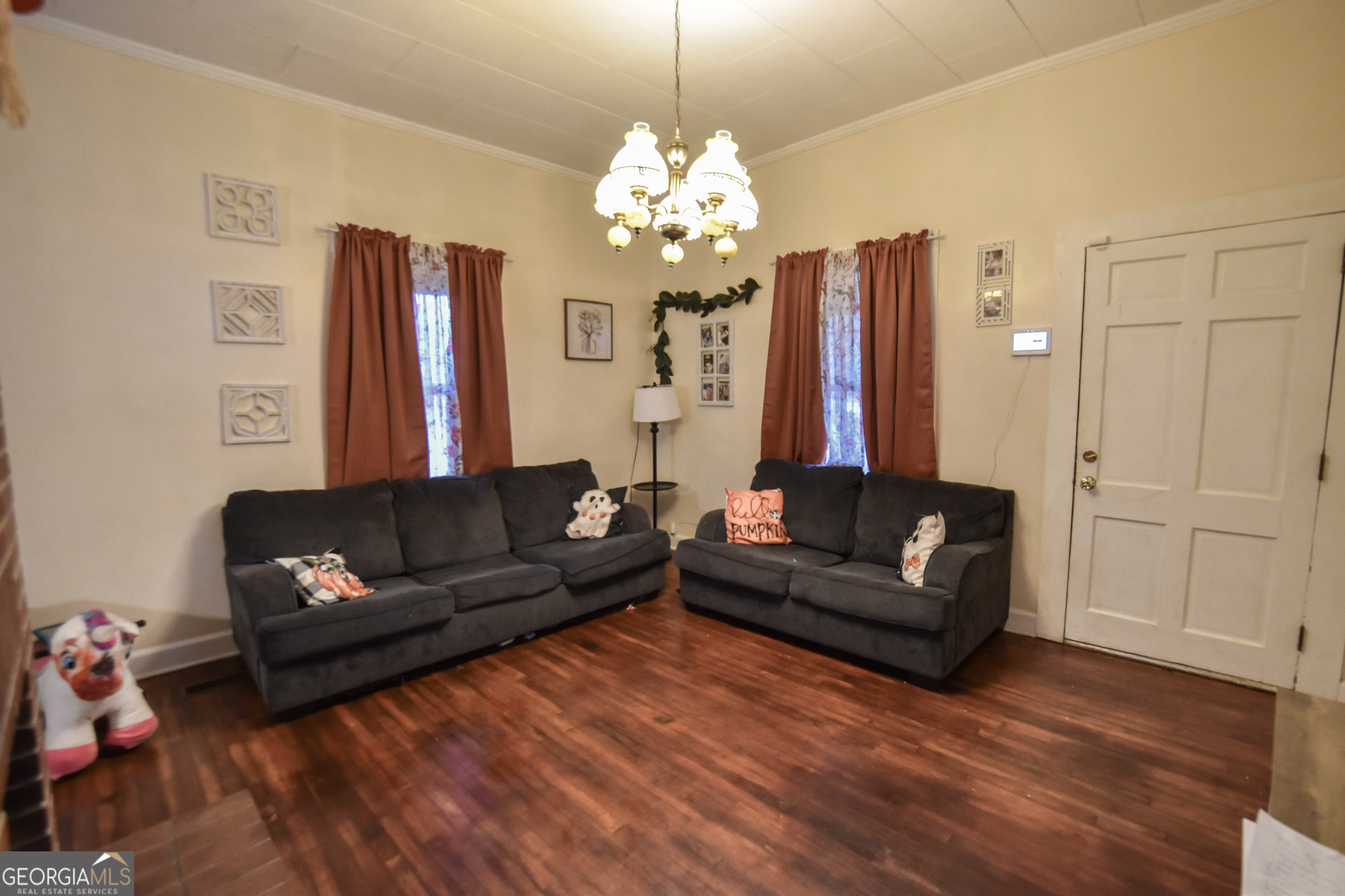 908 East McCarty Street Sandersville, GA 31082 - Photo 3 of 20 a living room with furniture and a chandelier
