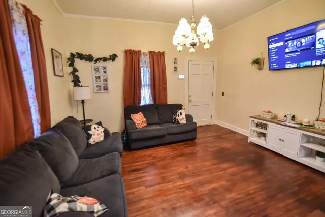 a living room with furniture and a chandelier