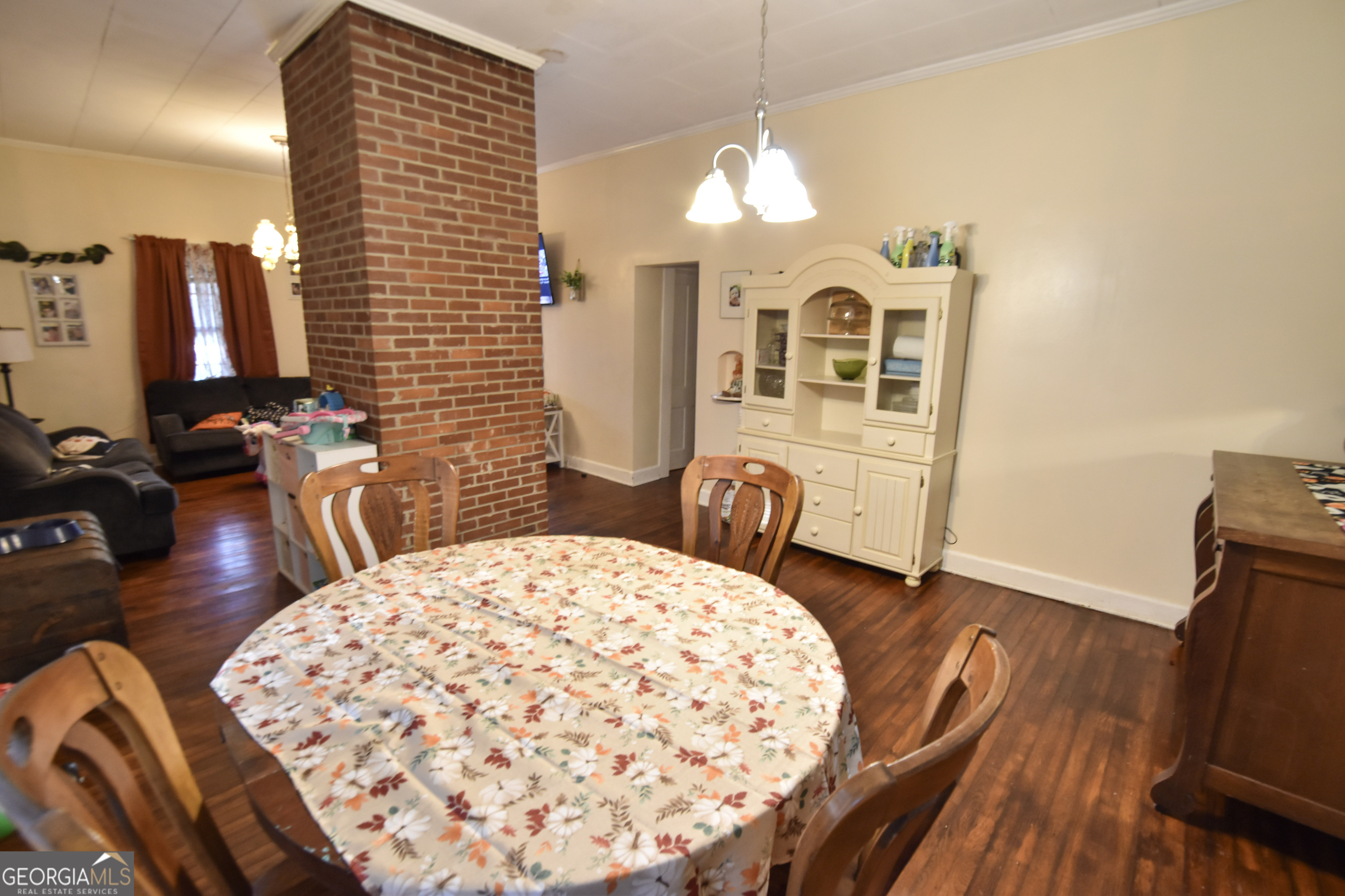 908 East McCarty Street Sandersville, GA 31082 - Photo 7 of 20 a view of a dining room with furniture and wooden floor