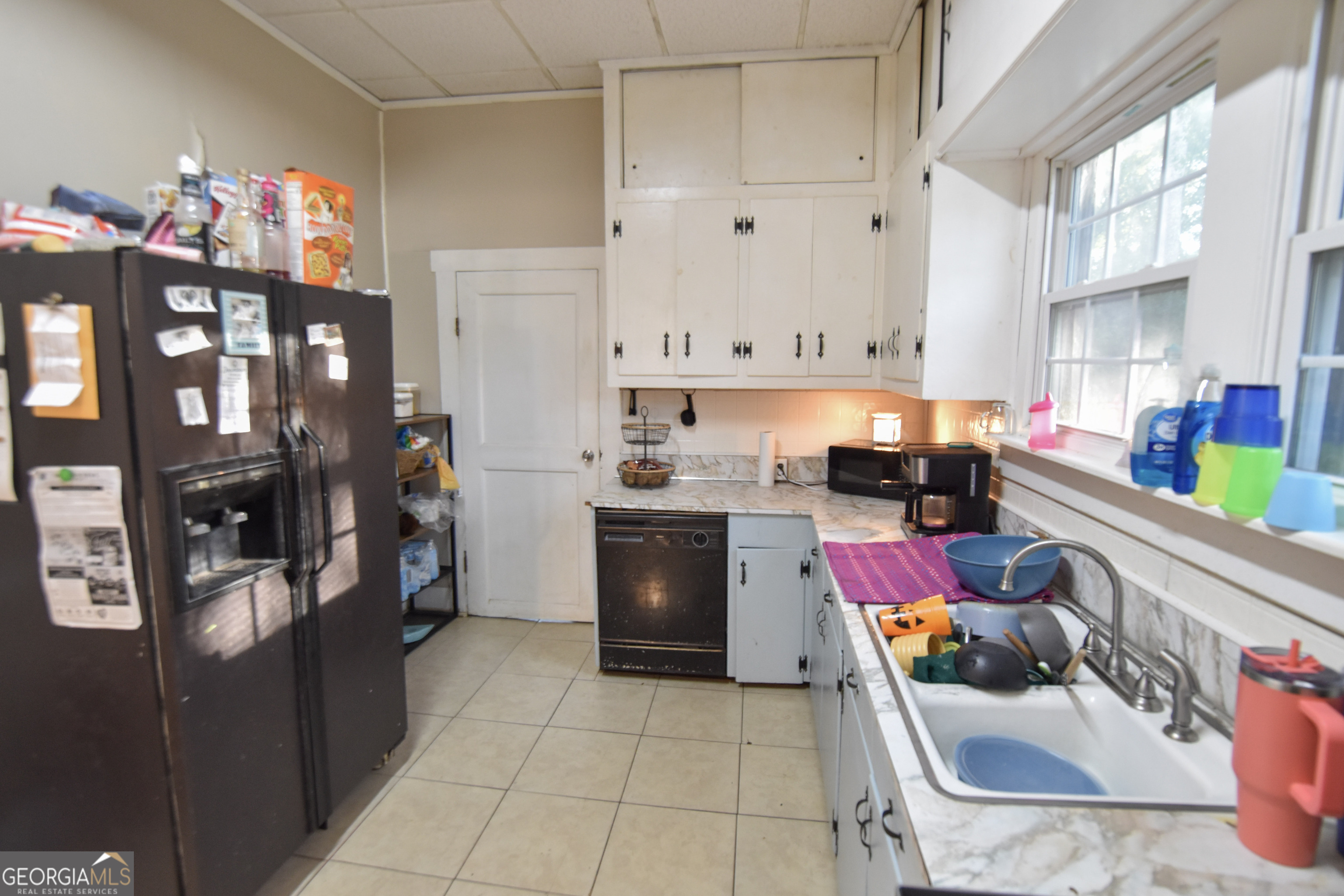 908 East McCarty Street Sandersville, GA 31082 - Photo 9 of 20 a kitchen with stainless steel appliances kitchen island granite countertop a refrigerator and sink