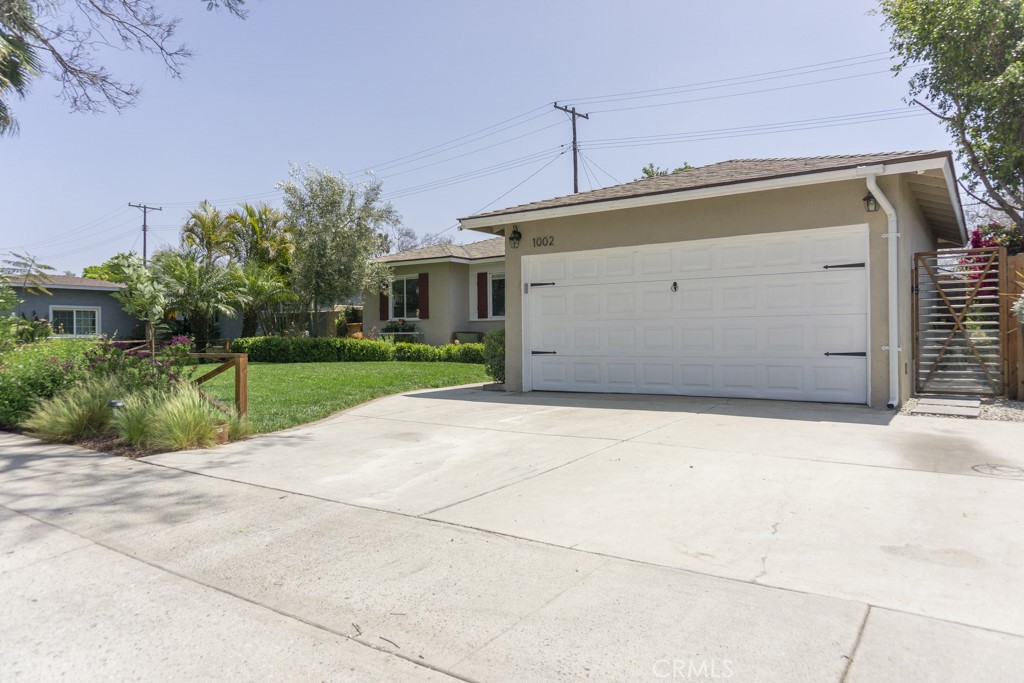 1002 Fairbrook Lane Santa Ana, CA 92706 - Photo 4 of 4 a front view of a house with a yard