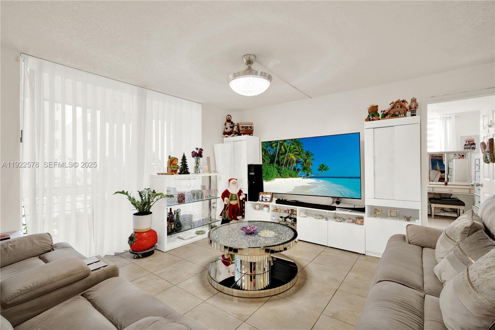 14195 Southwest 87th Street, Unit B115 Miami, FL 33183 - Photo 11 of 22 a living room with furniture and a flat screen tv