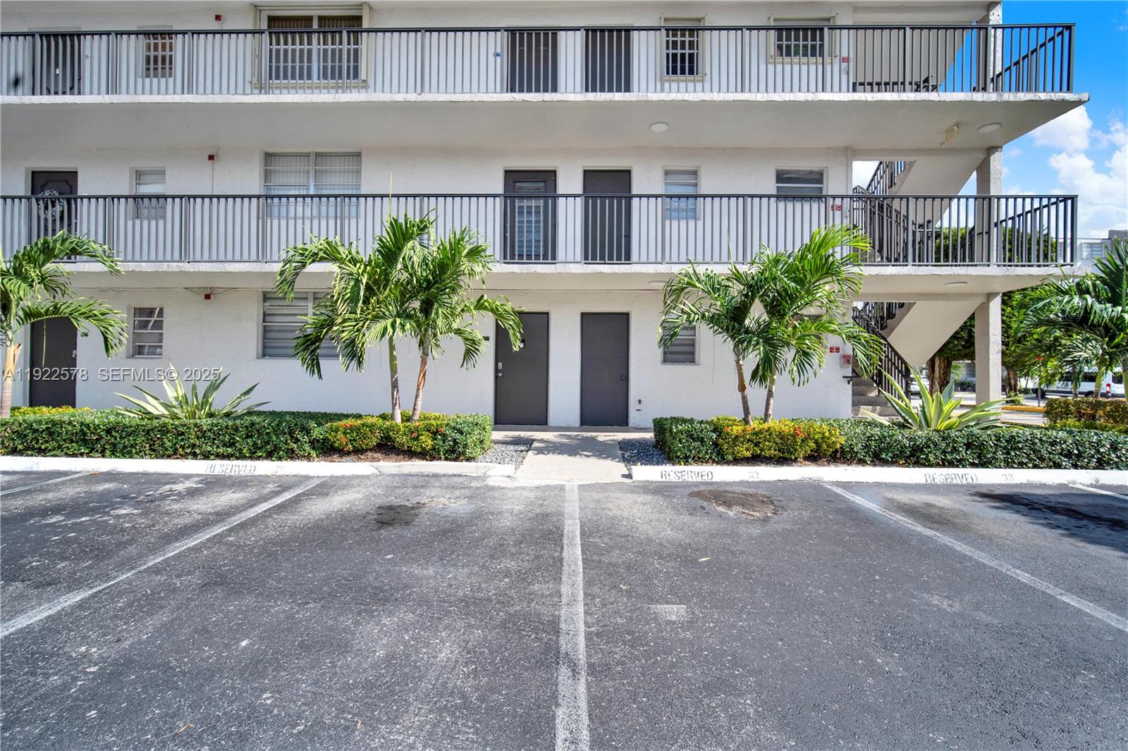 14195 Southwest 87th Street, Unit B115 Miami, FL 33183 - Photo 5 of 22 a front view of a building with plants