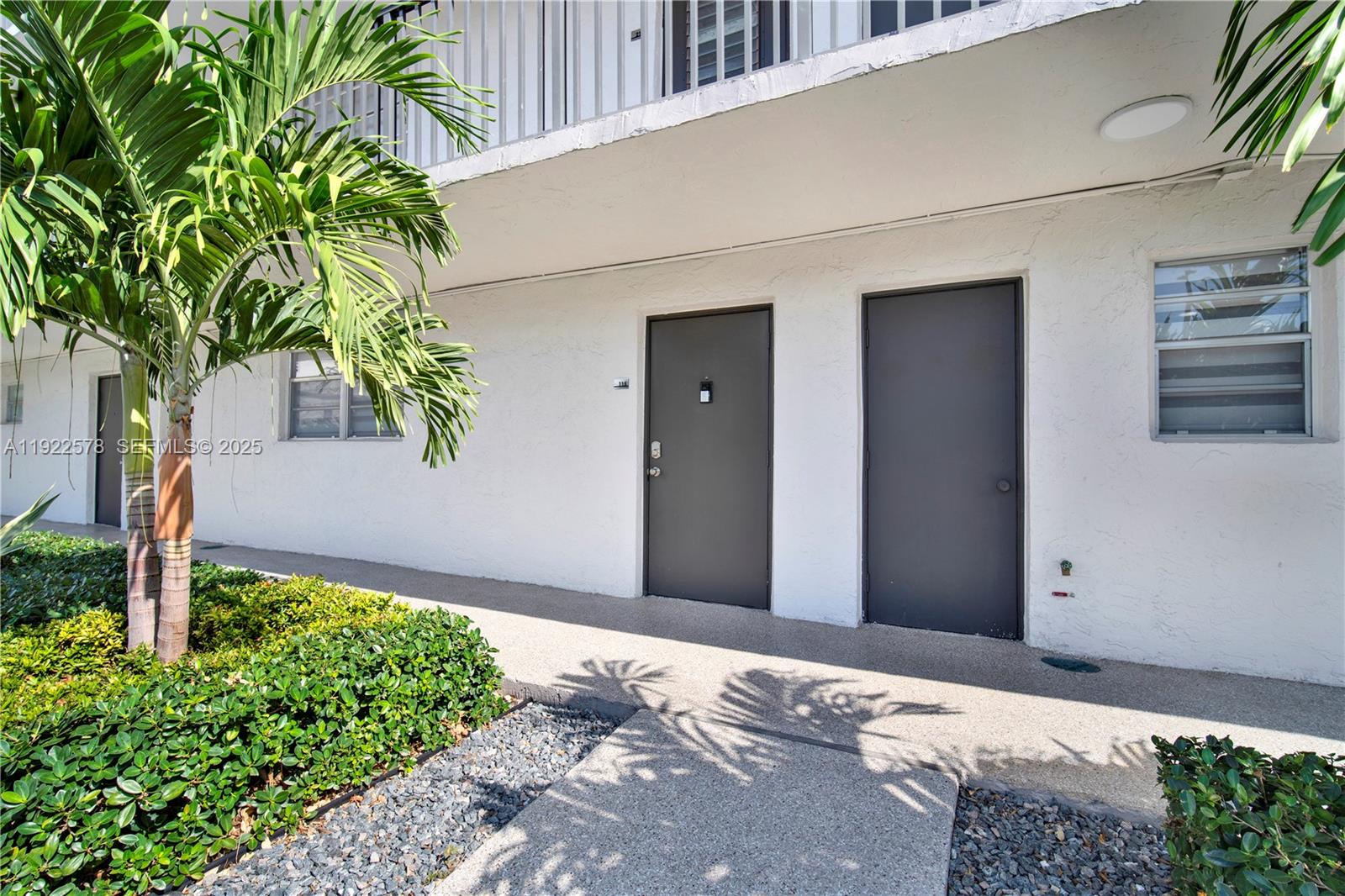14195 Southwest 87th Street, Unit B115 Miami, FL 33183 - Photo 6 of 22 a front view of a house with a yard
