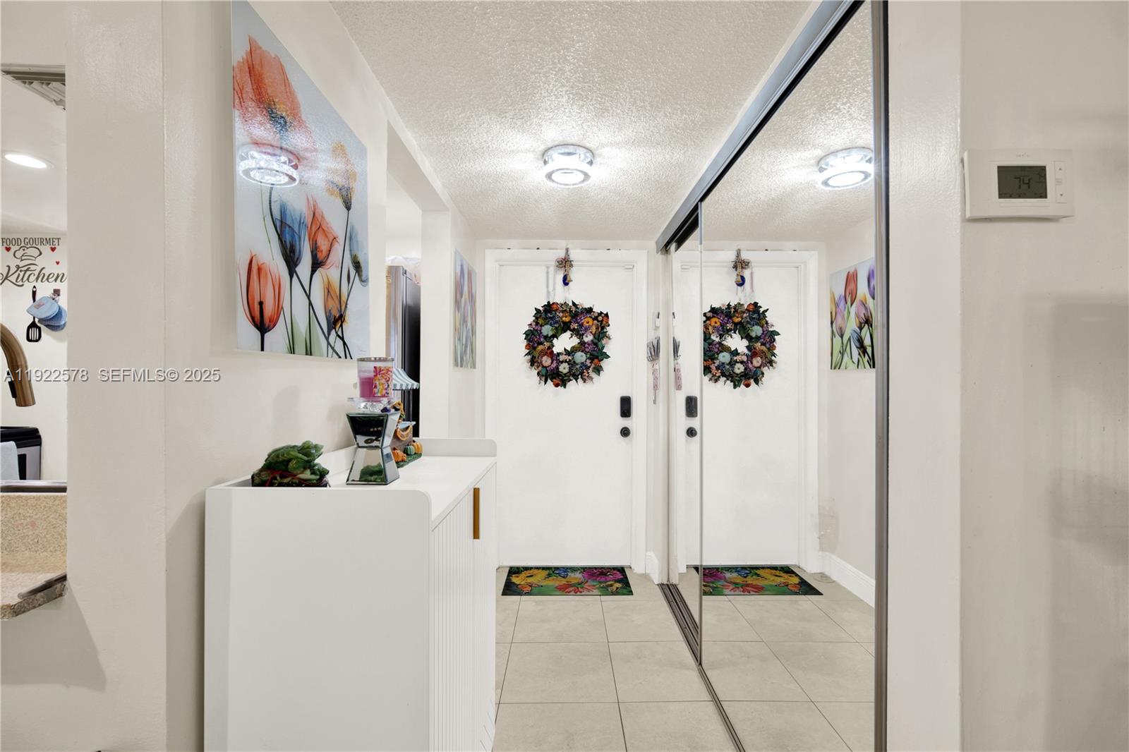 14195 Southwest 87th Street, Unit B115 Miami, FL 33183 - Photo 7 of 22 a hallway with a view of bathroom