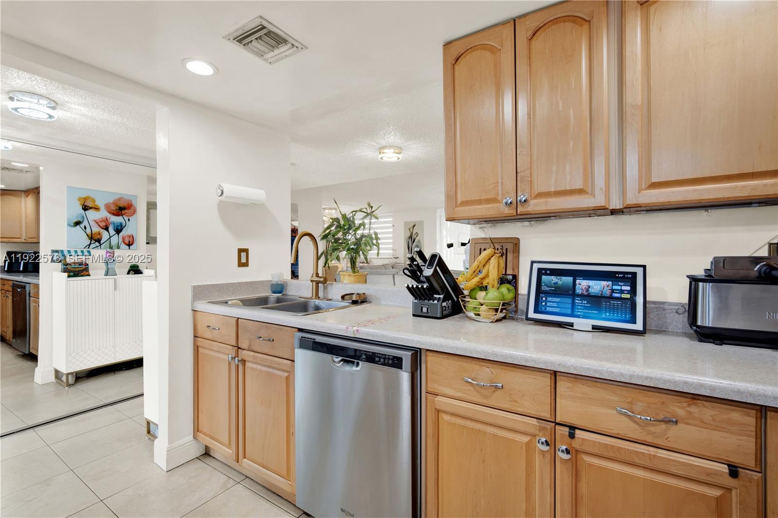 14195 Southwest 87th Street, Unit B115 Miami, FL 33183 - Photo 9 of 22 a kitchen with stainless steel appliances granite countertop a sink a stove and cabinets