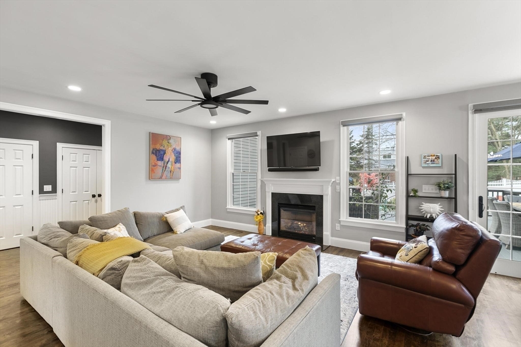 27 Sherman Street Lexington, MA 02420 - Photo 11 of 30 a living room with furniture a fireplace and a flat screen tv