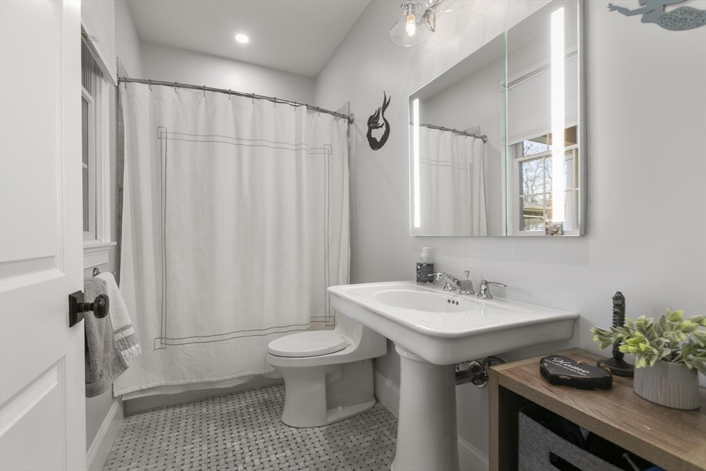 27 Sherman Street Lexington, MA 02420 - Photo 16 of 30 a bathroom with a sink a toilet and shower