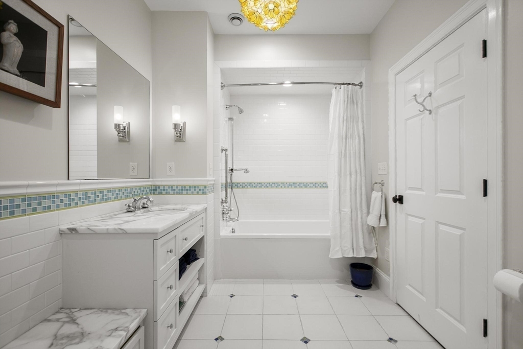 27 Sherman Street Lexington, MA 02420 - Photo 23 of 30 a bathroom with a sink a toilet and shower