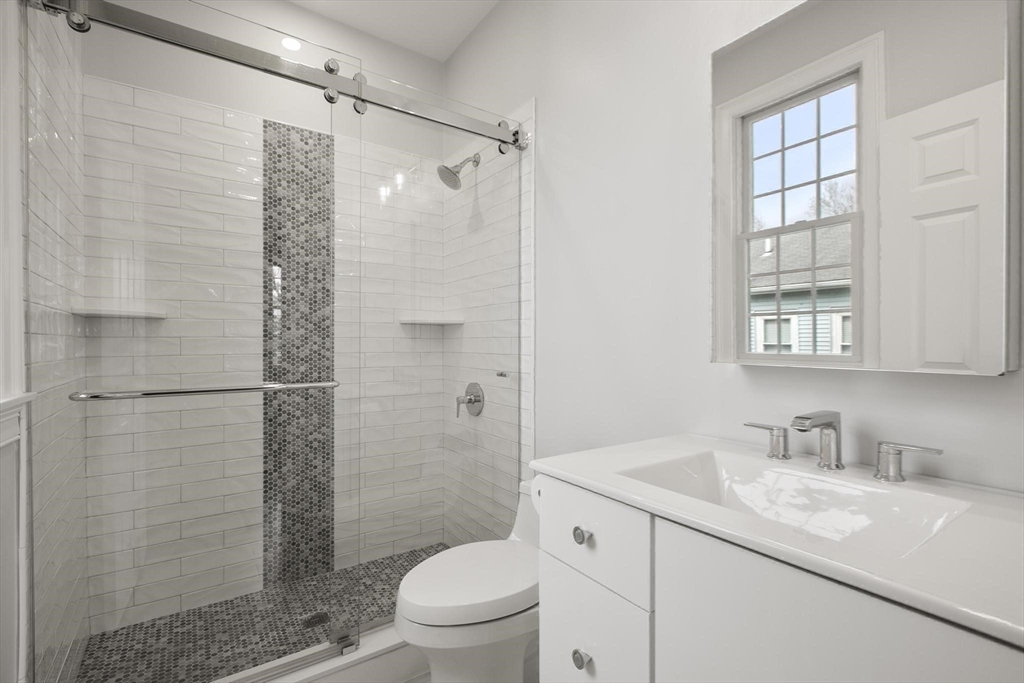27 Sherman Street Lexington, MA 02420 - Photo 25 of 30 a bathroom with a granite countertop sink toilet and shower