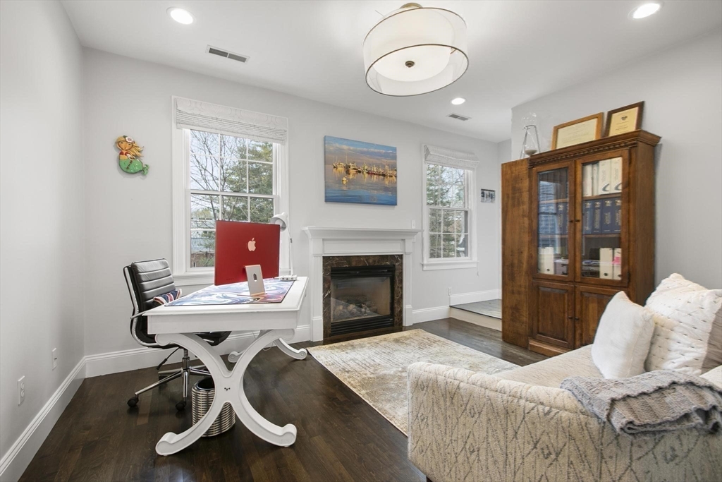27 Sherman Street Lexington, MA 02420 - Photo 26 of 30 a living room with furniture a flat screen tv and a fireplace