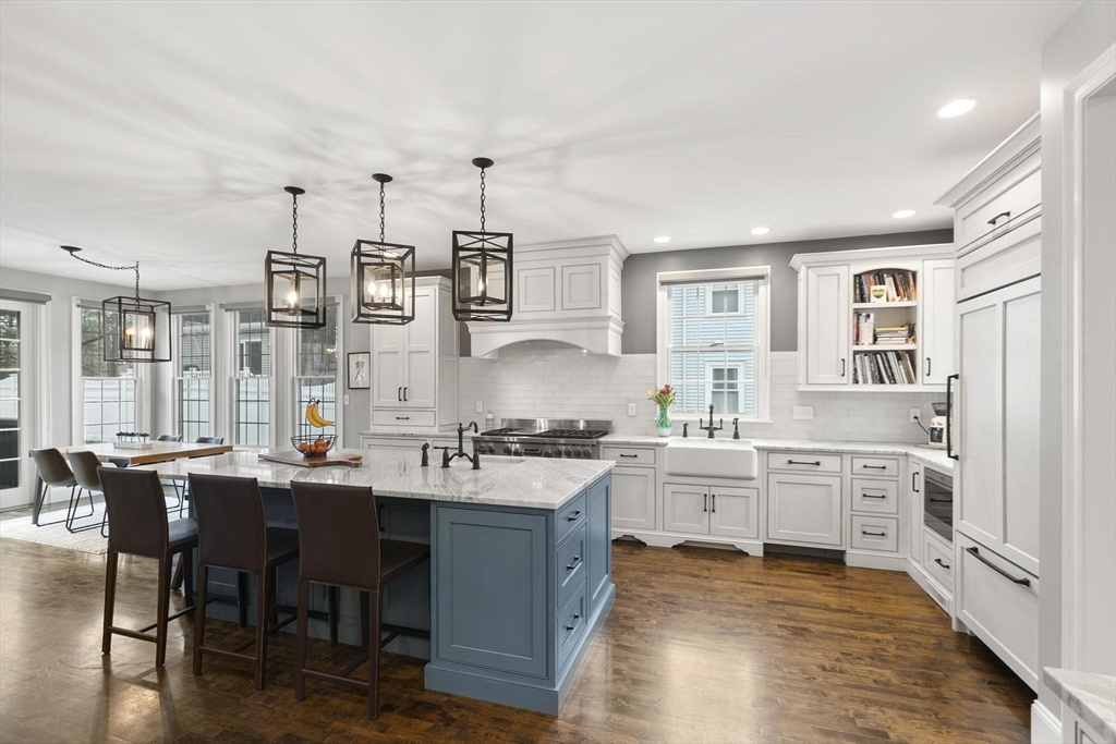 27 Sherman Street Lexington, MA 02420 - Photo 5 of 30 a large white kitchen with cabinets and wooden floor