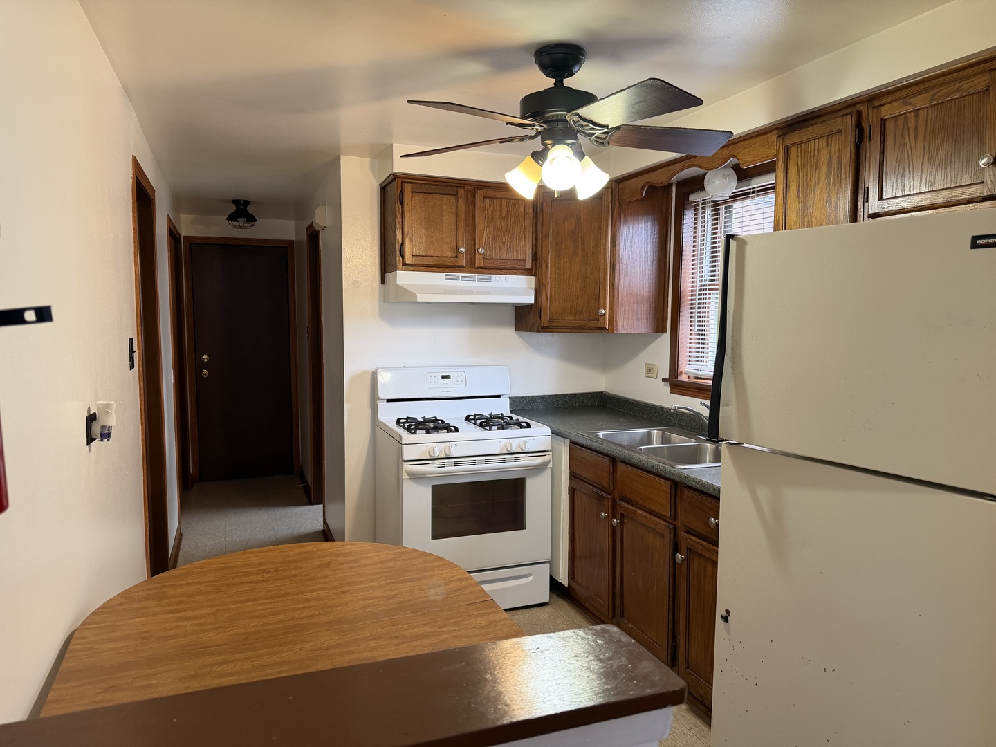 7226 West 63rd Place, Unit 1 Summit, IL 60501 - Photo 5 of 10 a kitchen with stainless steel appliances granite countertop a refrigerator a stove and a sink