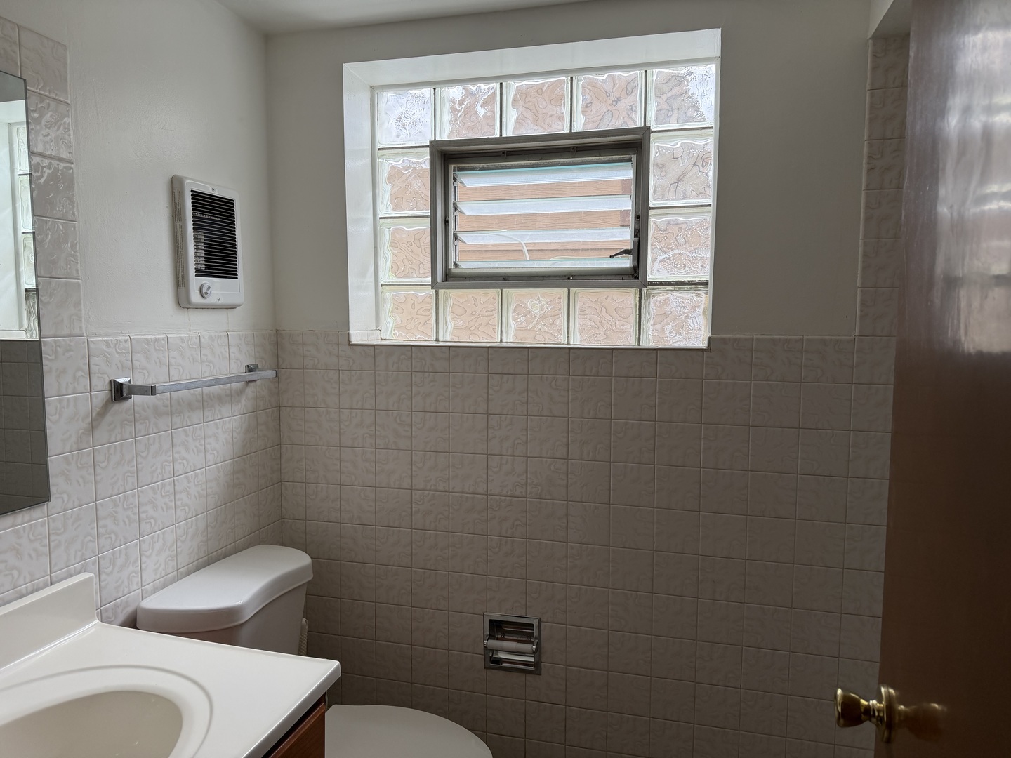 7226 West 63rd Place, Unit 1 Summit, IL 60501 - Photo 9 of 10 a bathroom with a toilet a sink and a window