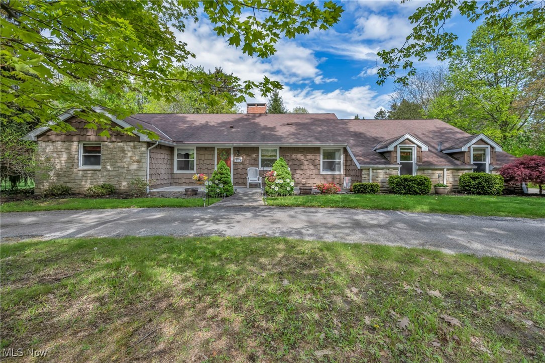 8665 Johnnycake Ridge Road Mentor, OH 44060 - Photo 1 of 49 Ranch-style home with a chimney, a front yard, and stone siding