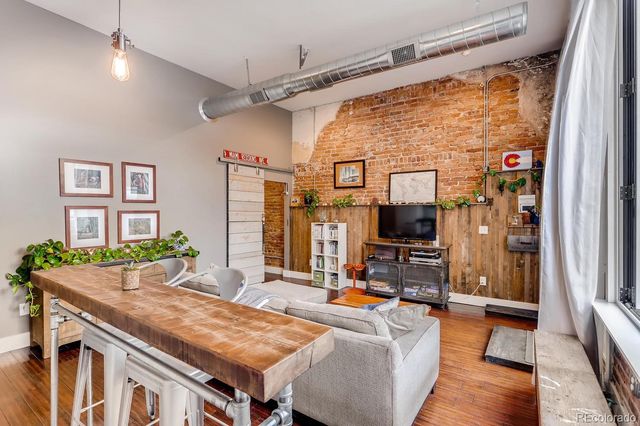 a living room with furniture and flat screen tv