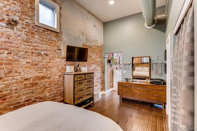 a bedroom with furniture and flat screen tv