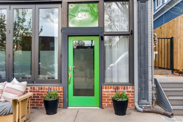 a front view of a house with outdoor seating and a potted plant