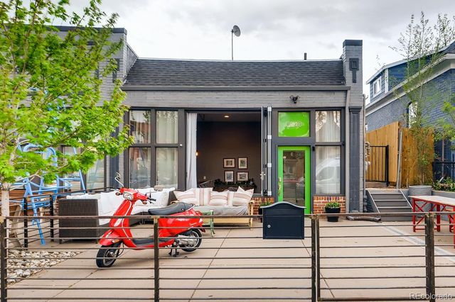 a backyard of a house with barbeque oven table and chairs