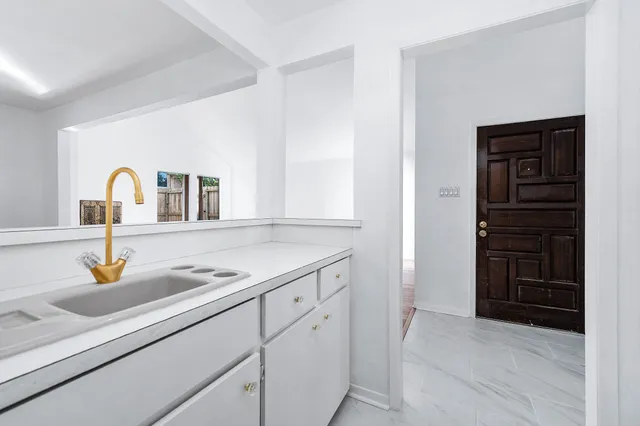 a kitchen with a sink and cabinets