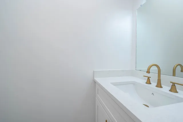 a bathroom with a sink and mirror