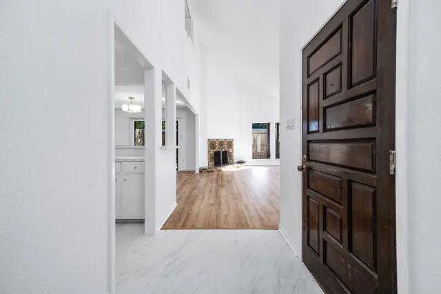 a view of a kitchen from a hallway
