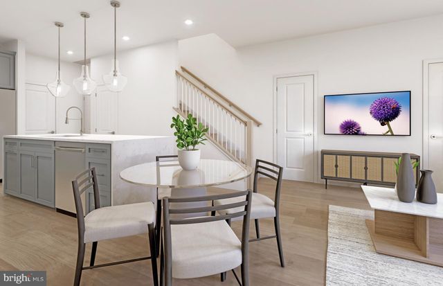 a view of a dining room with furniture and a potted plant