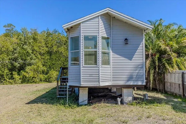 a view of a house with a yard and sitting area