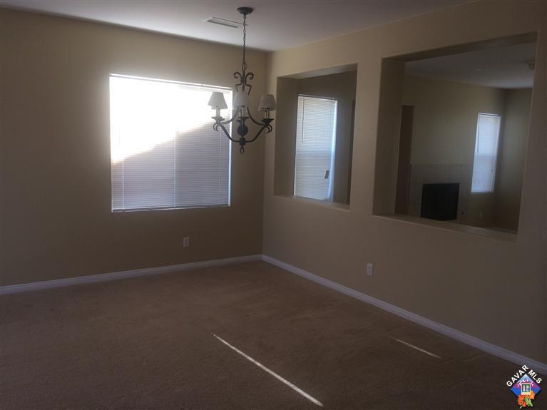 43757 Rucker Street Lancaster, CA 93535 - Photo 2 of 8 en empty room with windows and chandelier