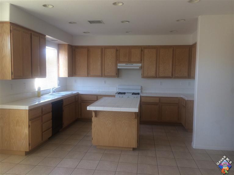 43757 Rucker Street Lancaster, CA 93535 - Photo 4 of 8 a kitchen with a cabinets and white stainless steel appliances