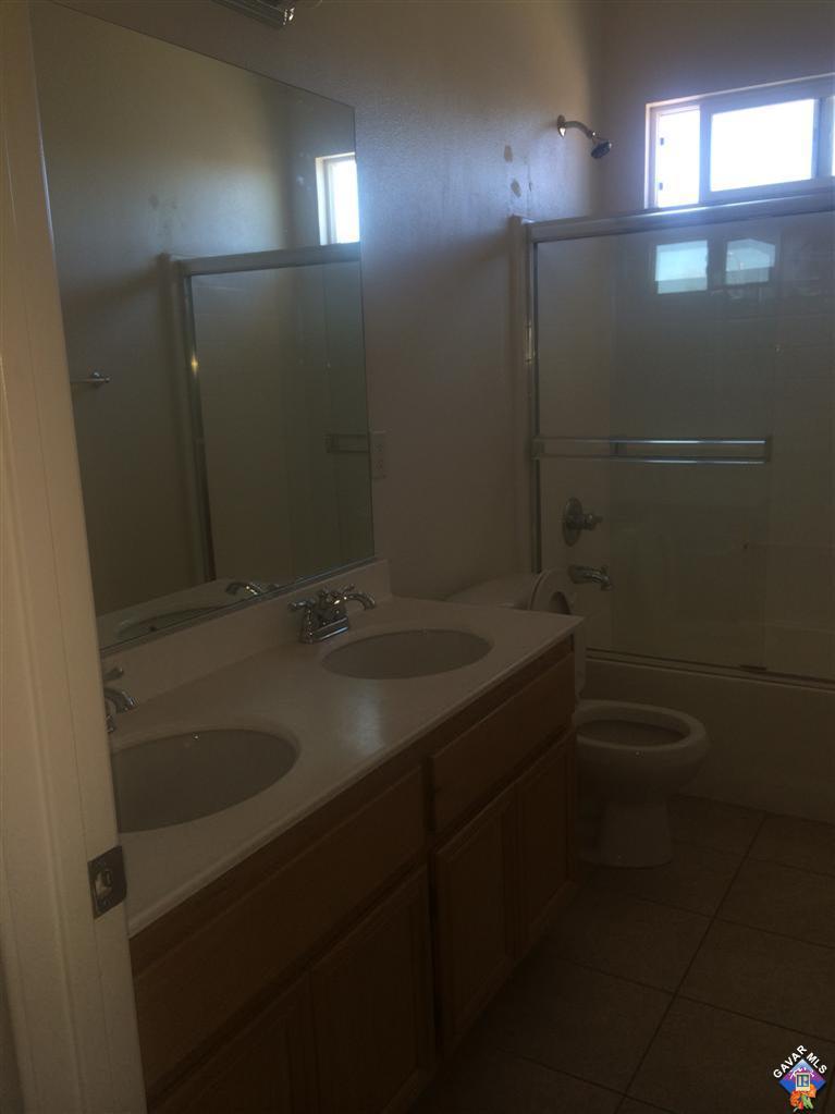43757 Rucker Street Lancaster, CA 93535 - Photo 6 of 8 a bathroom with a sink and mirror