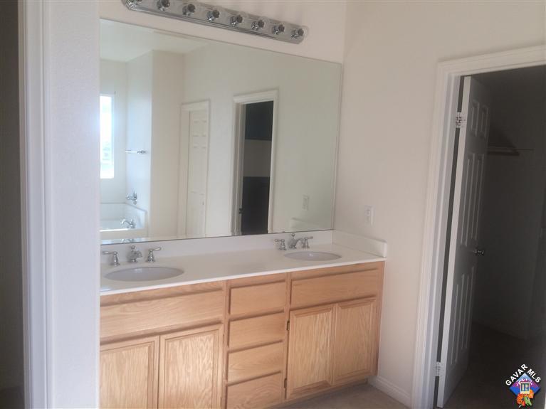 43757 Rucker Street Lancaster, CA 93535 - Photo 8 of 8 a bathroom with a sink and a mirror
