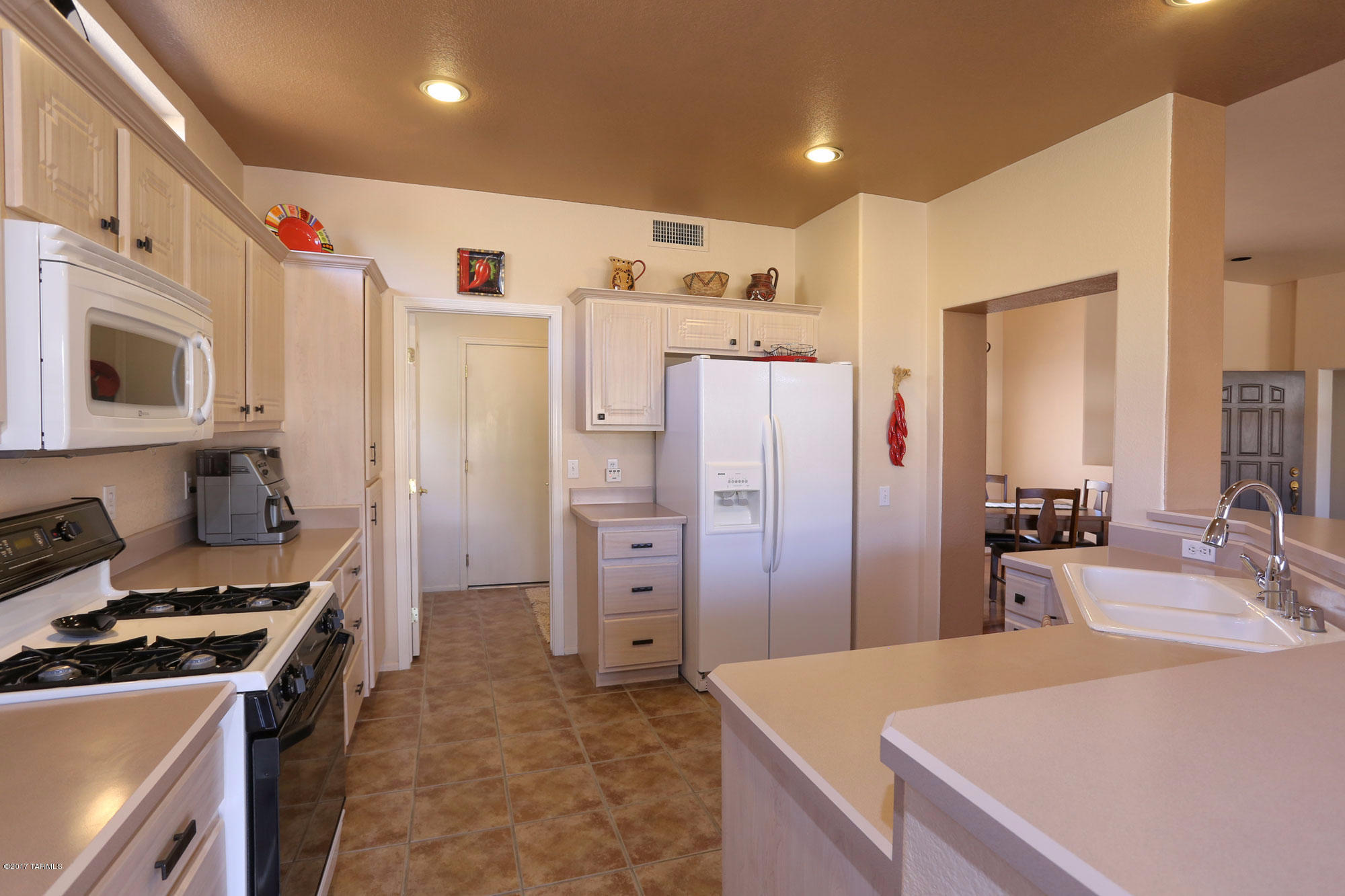 1065 East Royal Oak Road Oro Valley, AZ 85755 - Photo 11 of 19 a kitchen with stainless steel appliances granite countertop a refrigerator and a stove top oven